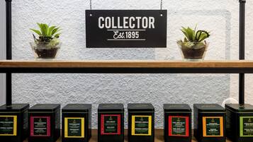 A shelf with potted plants and a sign that reads "COLLECTOR Est. 1895".