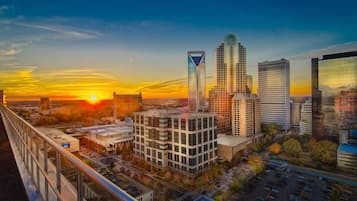 A cityscape with modern buildings and a sunset.