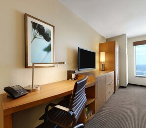 Enjoy a city view from the large window, with a flat-screen TV and comfortable seating area.