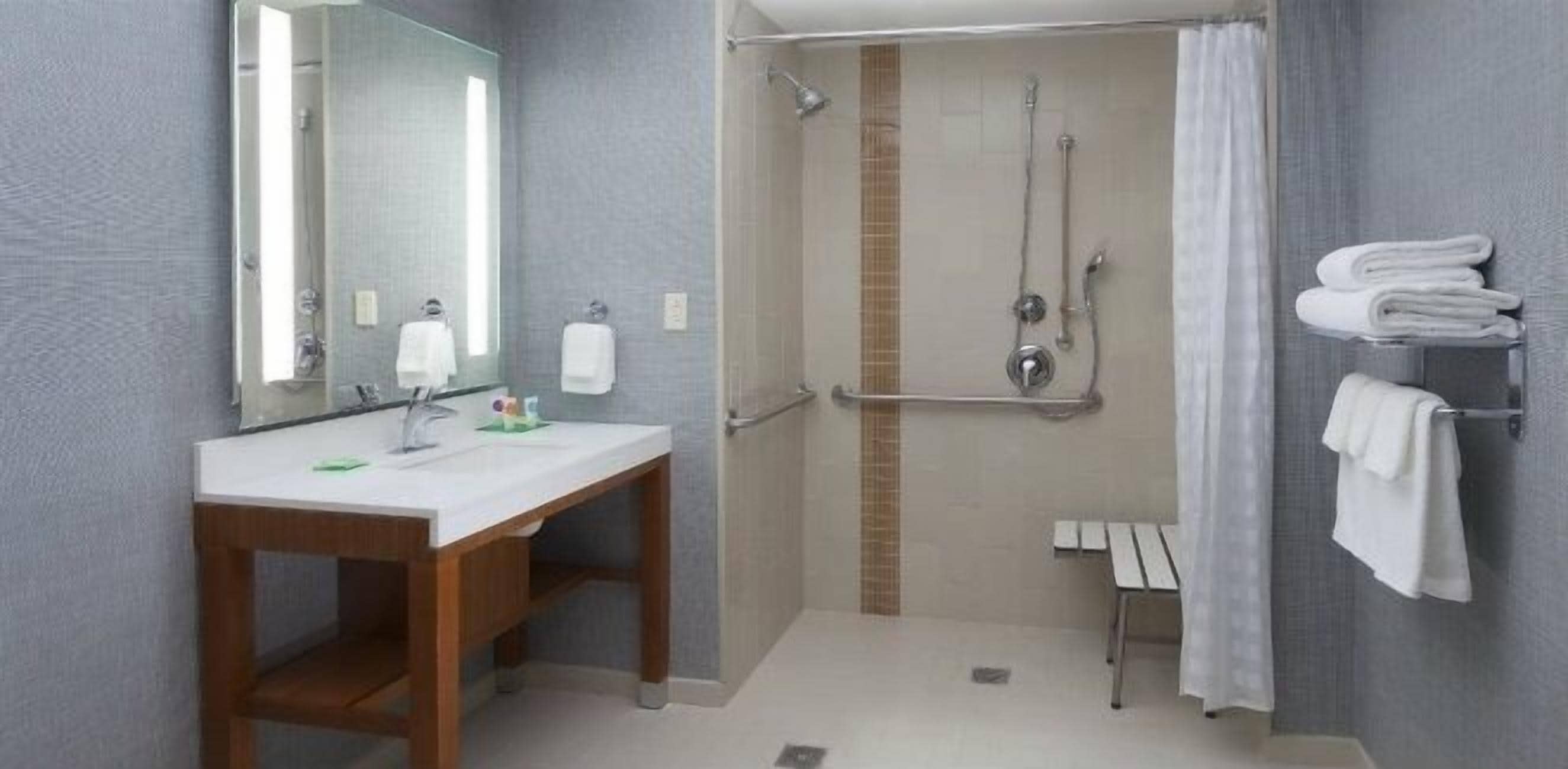 designer toiletries, hair dryer, towels