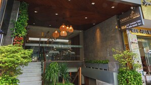 A hotel entrance with a sign reading "Cherry Boutique Hotel". - Cherry Boutique Hotel (Ho Chi Minh City)