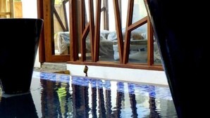 A pool area with a tiled floor and a wooden-framed window. - Dodola Lodge (Grand-Baie)