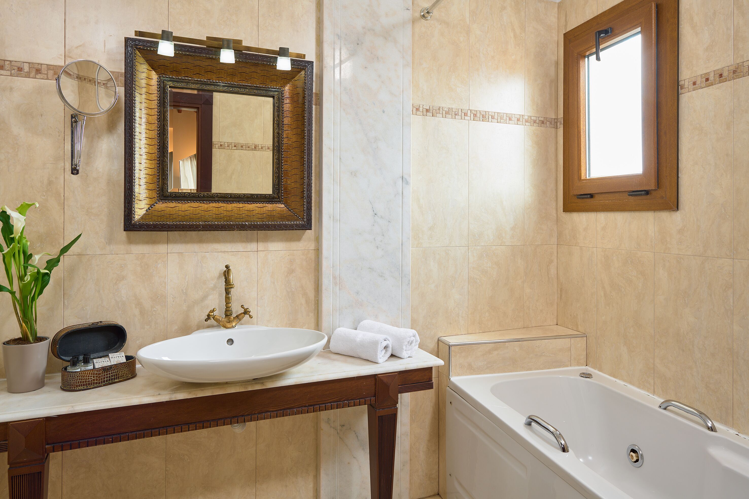 designer toiletries, hair dryer, slippers, towels