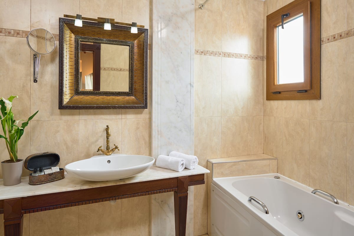 designer toiletries, hair dryer, slippers, towels