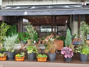 A storefront with the sign "Second Avenue Bistro" and various potted plants arranged outside. - Hotel Asyl Nara Annex (Nara)