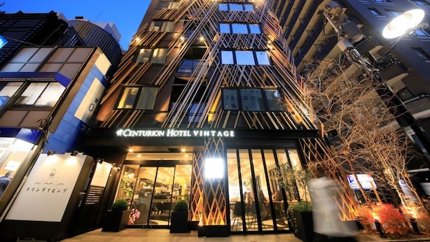 The exterior of Centurion Hotel Vintage with a modern architectural design, featuring a prominent entrance and illuminated signage. - Centurion Hotel Grand Akasaka (Tokyo)
