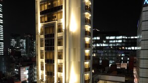 A high-rise hotel with multiple floors, illuminated windows, and a modern architectural design. - Centurion Hotel Grand Akasaka (Tokyo)