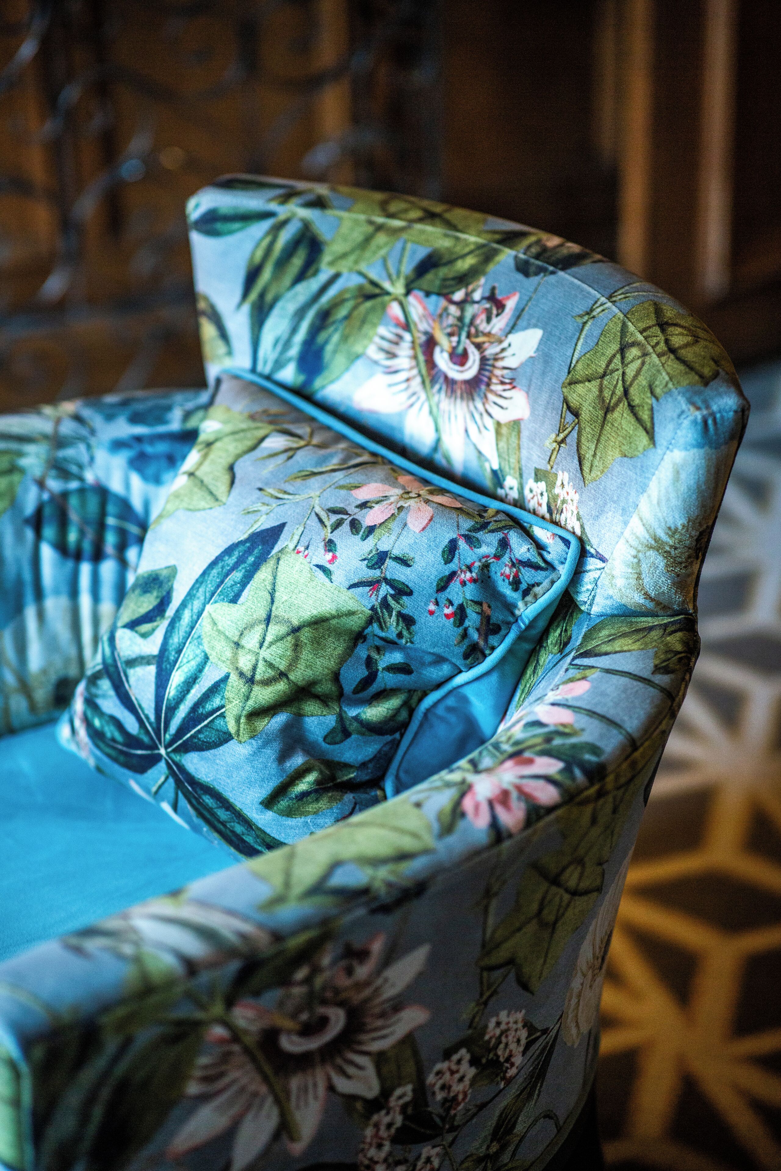 A chair with a floral pattern upholstery.