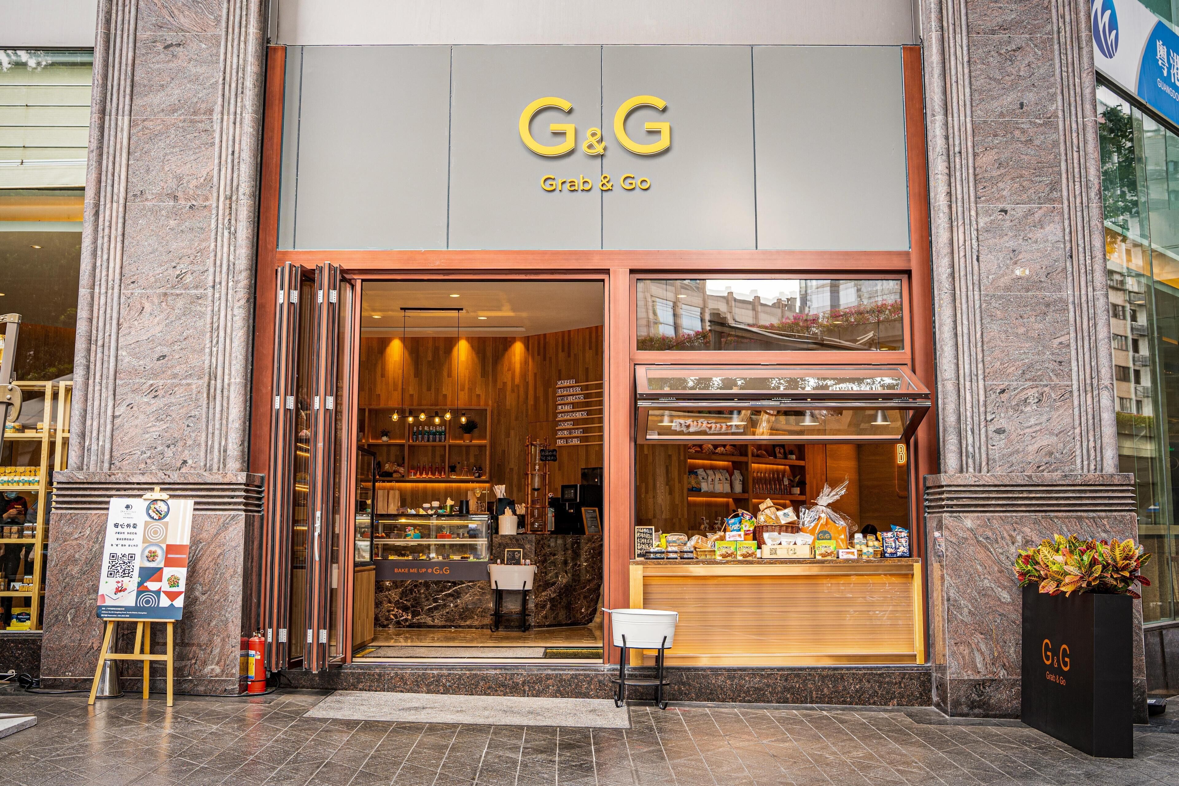 A G&G Grab & Go store with a marble facade, a visible interior with shelves and products, and a signboard outside.