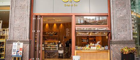 A G&G Grab & Go store with a marble facade, a visible interior with shelves and products, and a signboard outside.