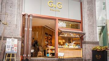 A G&G Grab & Go store with a wooden interior, a visible counter, and a neon sign.