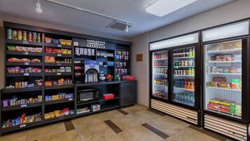 A snack and beverage vending area with various snack options and a refrigerated beverage section.