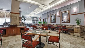 A spacious restaurant with high ceilings, chandeliers, and a variety of seating arrangements including tables and booths. - Hotel Sahid Jaya Makassar City Centre (Makassar)