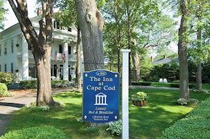 A sign for The Inn at Cape Cod, indicating it offers luxury bed and breakfast services. - The Inn At Cape Cod (Yarmouth Port)