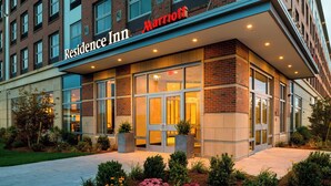 A Marriott Residence Inn building with a modern facade, large glass windows, and a well-maintained entrance area. - Residence Inn Boston Needham (Needham)