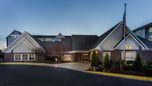 A hotel with a brick facade, a flagpole, and a well-lit entrance. - Residence Inn Largo Medical Center Drive (Upper Marlboro)