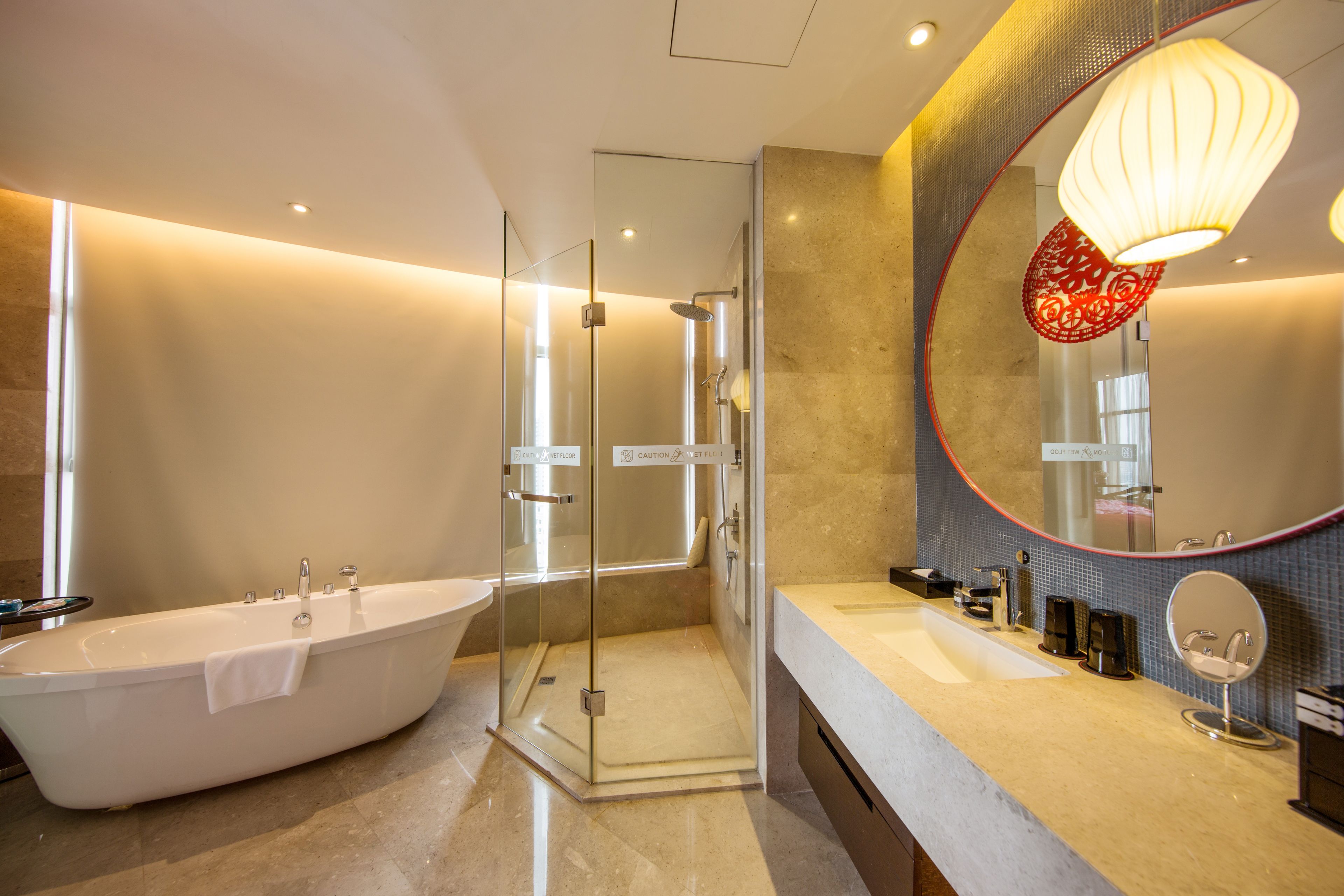 deluxe suite | bathroom | designer toiletries, hair dryer, bathrobes, slippers