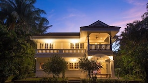 A two-story building with a balcony and a covered porch area. - Baan Khun Nang Colonial Residence (Koh Samui)
