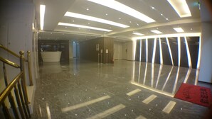 A hotel lobby with a reception desk, a staircase, and a 'Welcome' sign. - City Hotel Taipei (Taipei)
