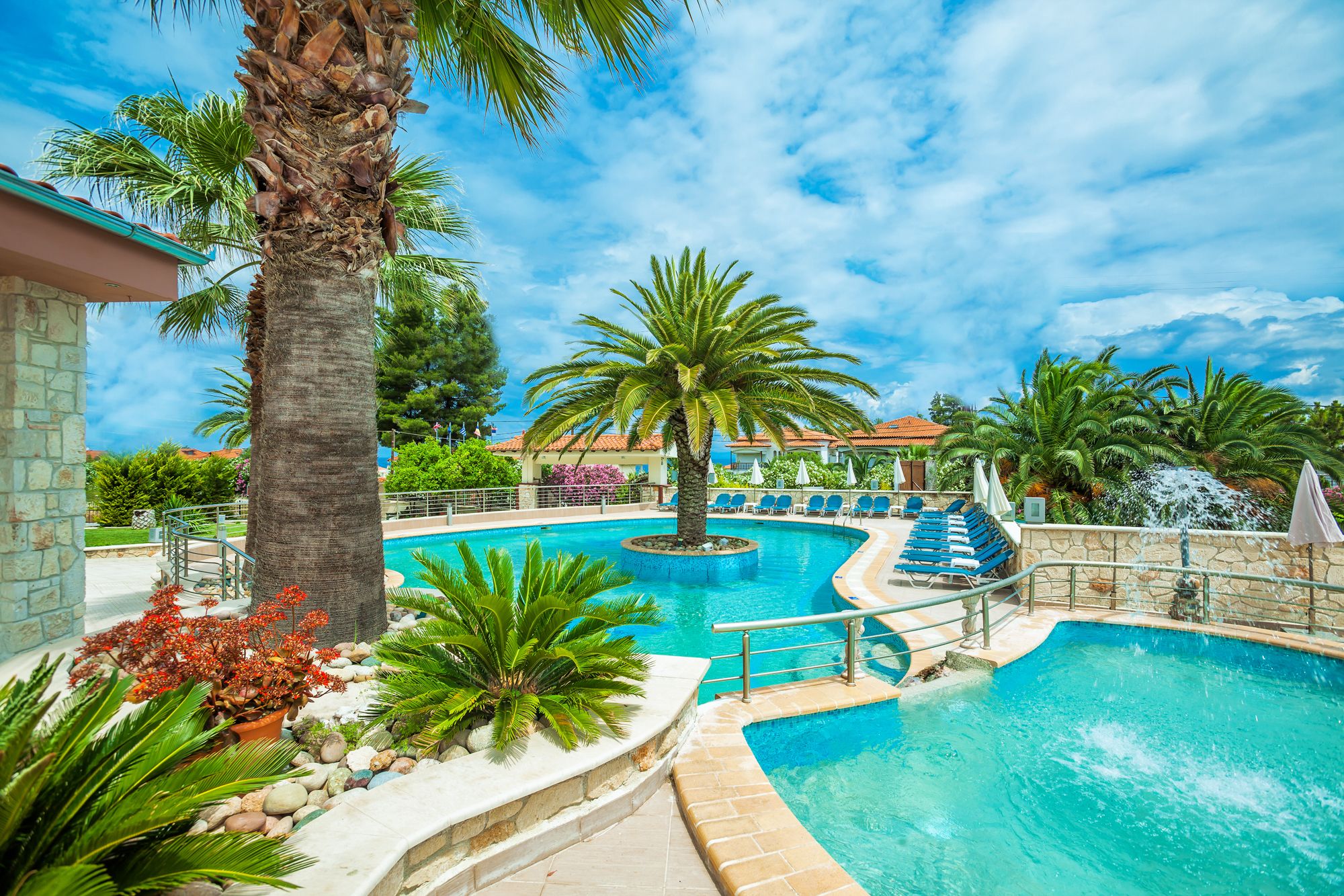 Outdoor pool, a waterfall pool, open 9:00 AM to 7:00 PM, pool umbrellas