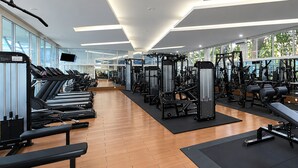 A gym with treadmills, weight machines, and a large mirror. - Sunlake Waterfront Resort and Convention (Jakarta)