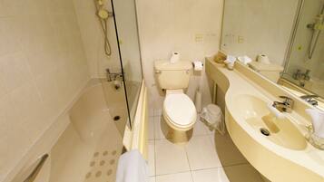 A bathroom with a bathtub, toilet, and sink.