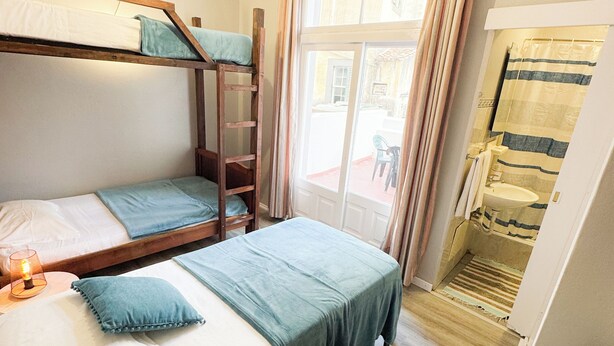 A dormitory room with bunk beds, a desk, a chair, and a window with curtains. - Residencial Monaco 38051-AL (Funchal)