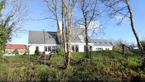 A house with a sloped roof, large windows, and a visible chimney. - Camillaun Lodge (Oughterard)