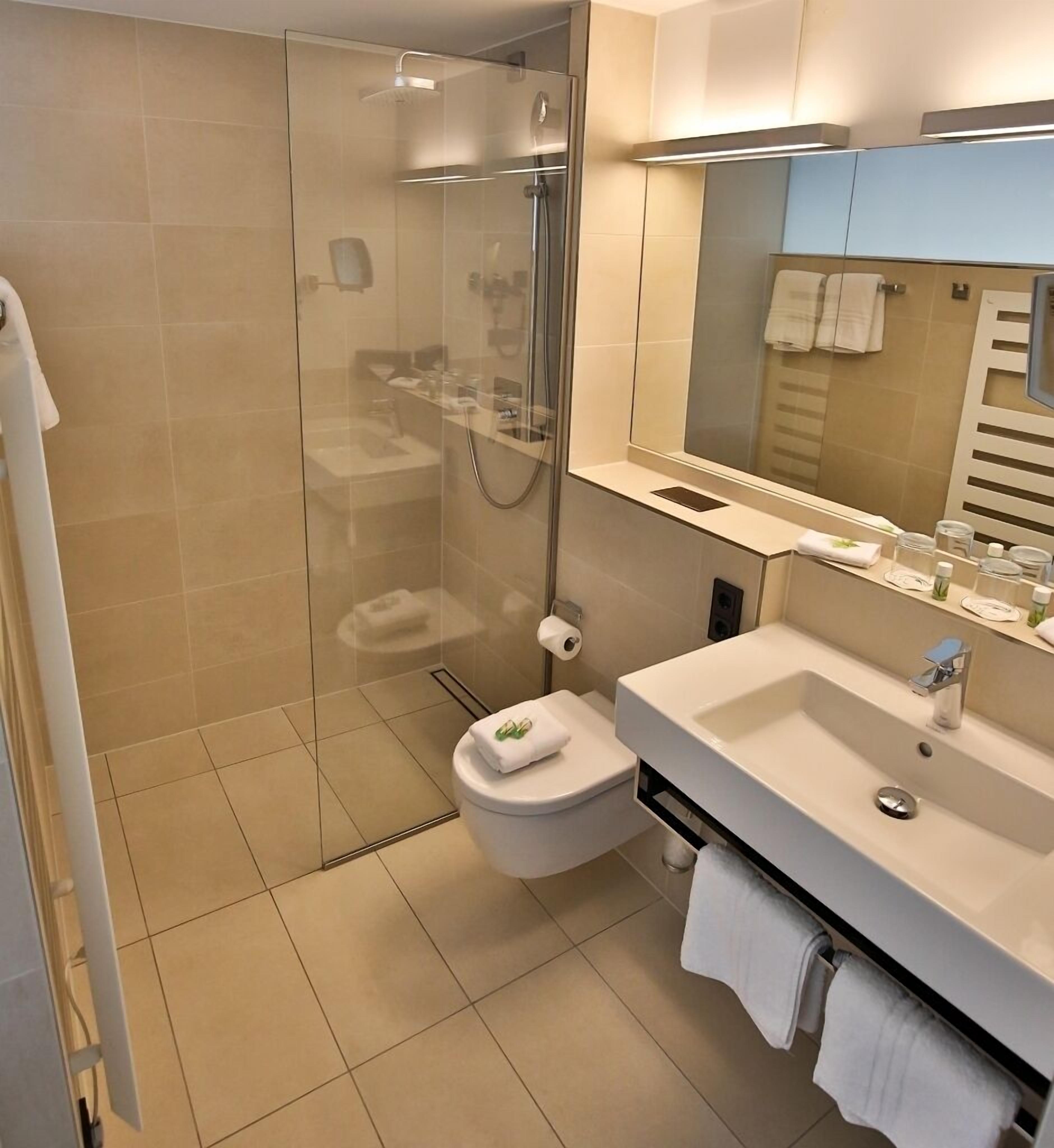 junior suite | bathroom | shower, hair dryer, towels