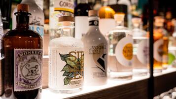A variety of alcohol bottles on a shelf.