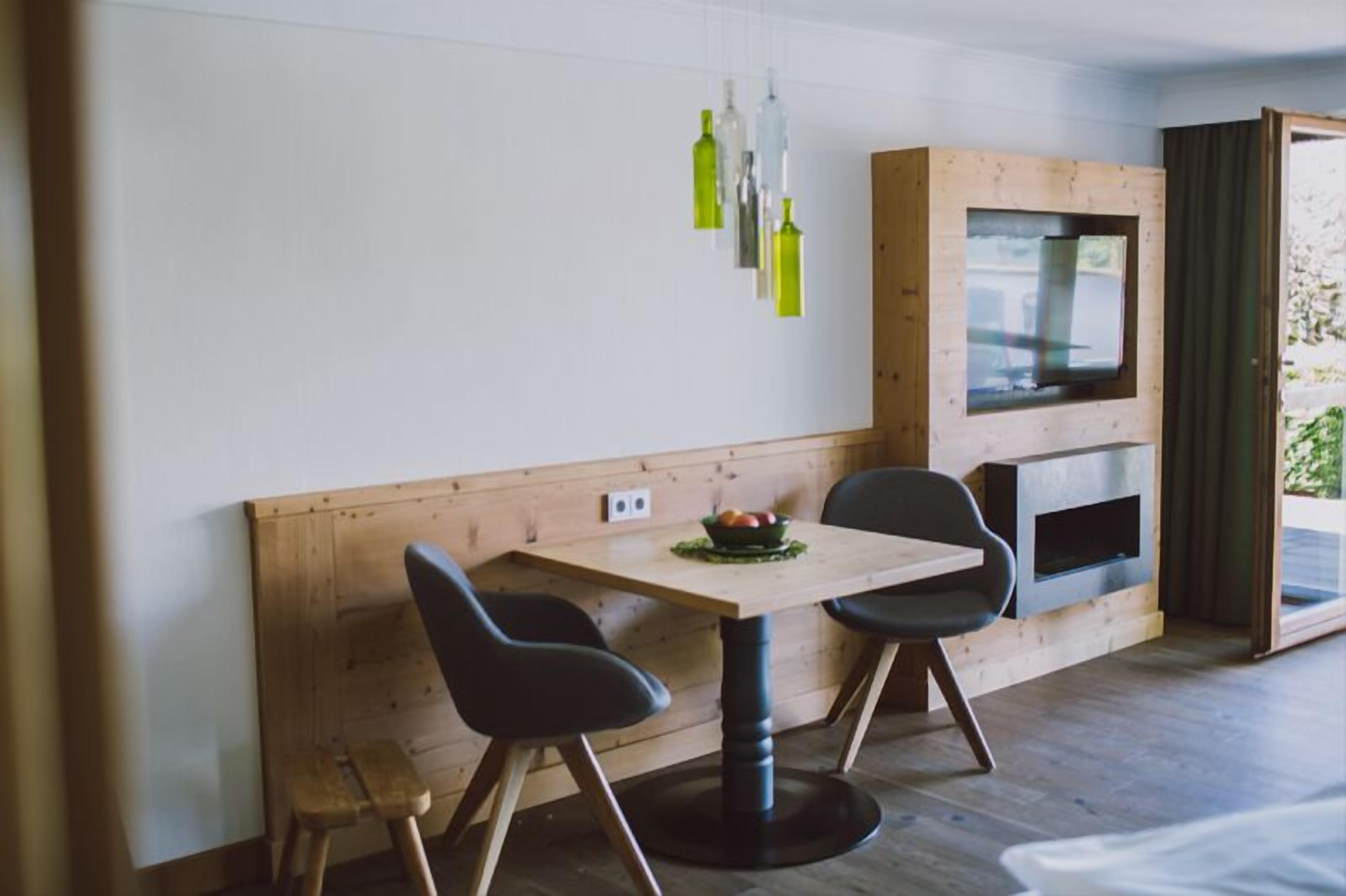 premium quadruple room, fireplace, lake view | living area | flat-screen tv