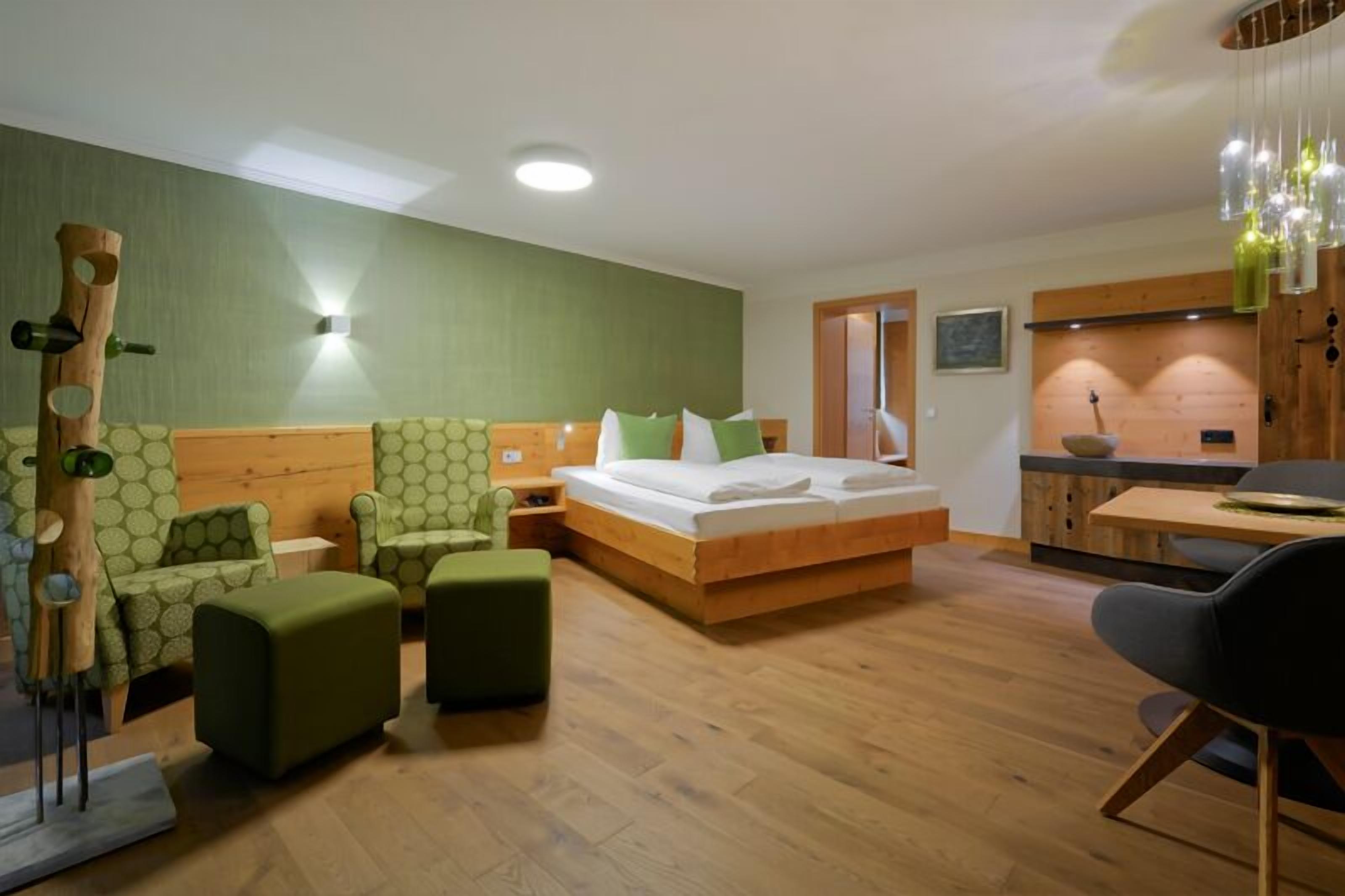 premium quadruple room, fireplace, lake view | living area | flat-screen tv