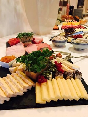 Enjoy a diverse and satisfying dining experience with a carefully arranged selection of cheeses, fruits, and delicacies.