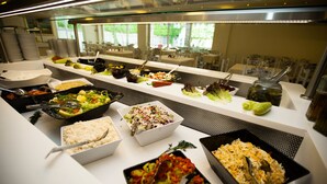 A buffet with various food items and utensils. - Olympic Kosma Hotel (Kassandra)