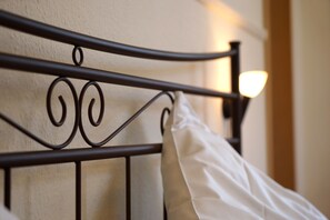 A metal bed frame with a white pillow. - Hotel Gasthaus Schützen (Freiburg im Breisgau)