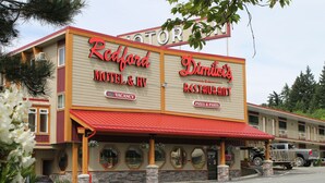 A motel and restaurant named 'Redford' with a red roof and beige walls. - Redford Motel (Port Alberni)