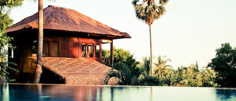 Outdoor pool, an infinity pool, pool umbrellas, pool loungers