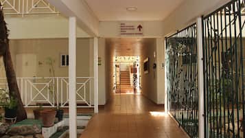 A hotel corridor with a sign indicating the direction to the bar, restaurant, board room, pool, and conference rooms.