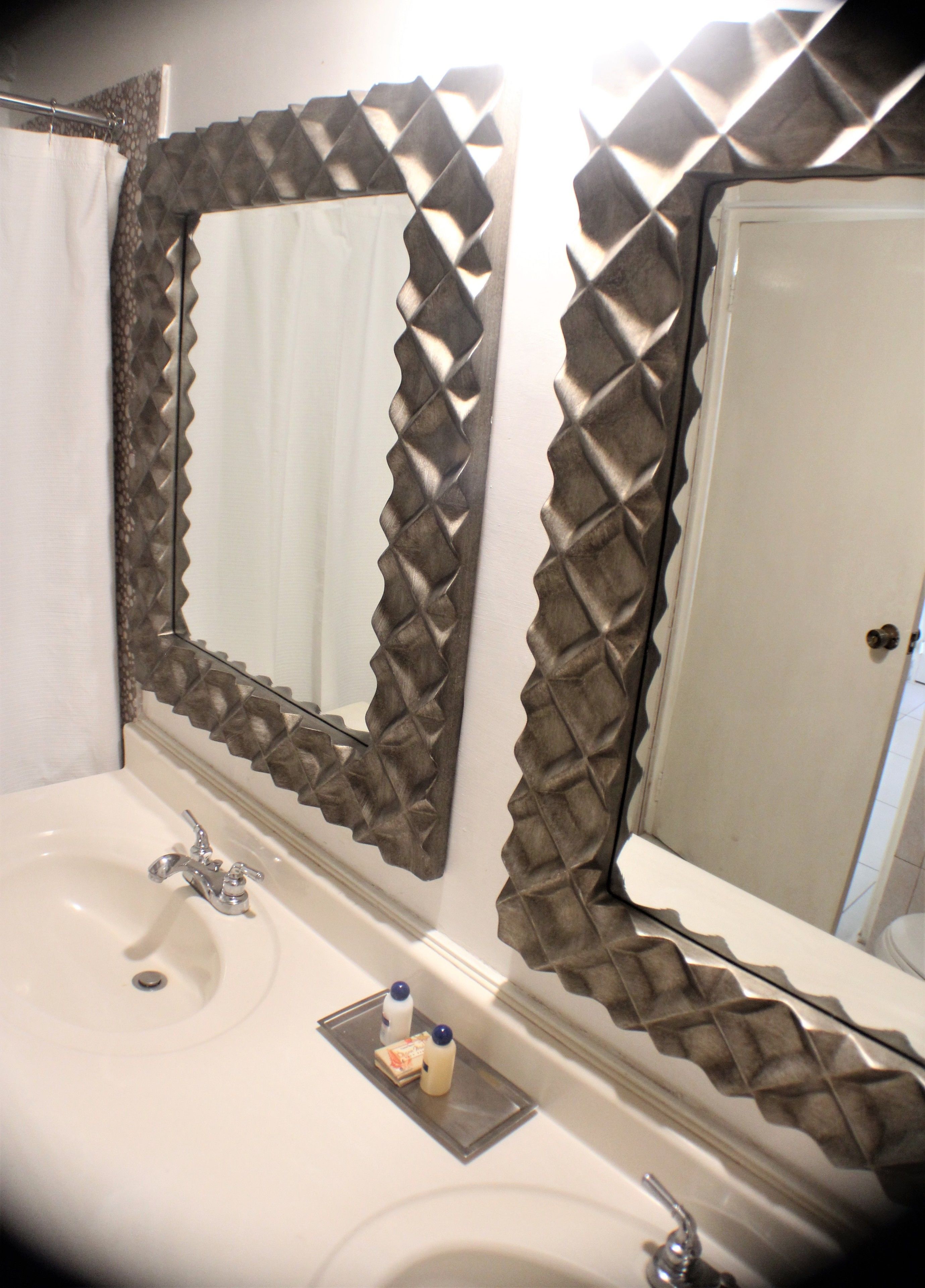 A bathroom with a sink, mirror, and shower curtain.