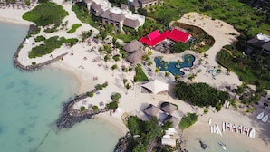 An aerial view of a resort with a beach, a swimming pool, and several buildings. - Zilwa Attitude (Calodyne)
