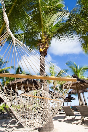 On the beach, white sand, sun-loungers, beach umbrellas