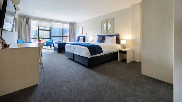 A modern hotel room with a large bed, a desk, and a chair. - U Residence Hotel, Signature Collection by BW (Wellington)