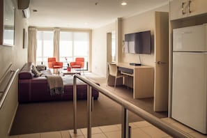 Deluxe Apartment, 1 Bedroom | Living area | 50-inch LCD TV with premium channels, TV, Netflix