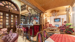 A luxurious interior with a bar area, plush seating, and ornate decor. - Q Hotel (Beirut)