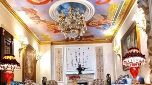 A luxurious room with a marble floor, a chandelier, and a ceiling mural. - Q Hotel (Beirut)