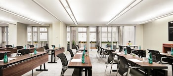 A room with a desk, chair, lamp, bookshelf, television, speakers, and a plant. at Hyatt Centric Times Square New York
