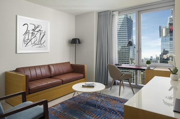 A gym with treadmills, weight machines, and mirrors. at Hyatt Centric Times Square New York