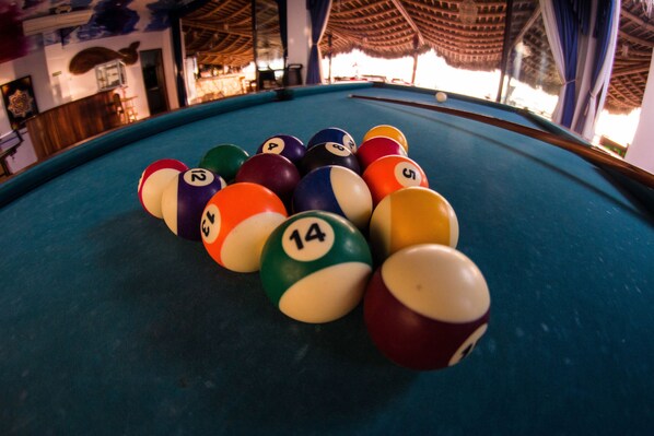 A pool table with numbered balls arranged in a triangle.
