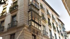 A multi-story building with balconies, large windows, and a classic architectural style. - Pensión Basque Boutique (Bilbao)