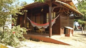 A wooden house with a porch and a hammock. - Pousada Ares de Noronha (Fernando de Noronha)